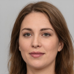 Joyful white young-adult female with long  brown hair and green eyes