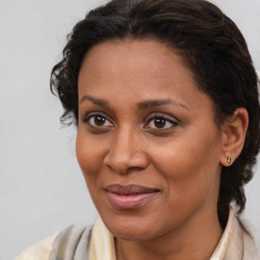 Joyful latino adult female with medium  brown hair and brown eyes