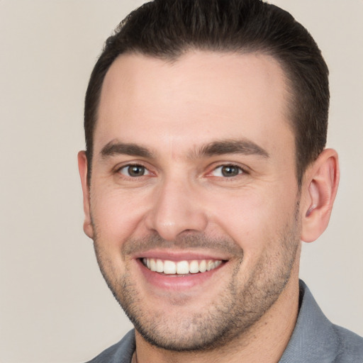 Joyful white young-adult male with short  brown hair and brown eyes