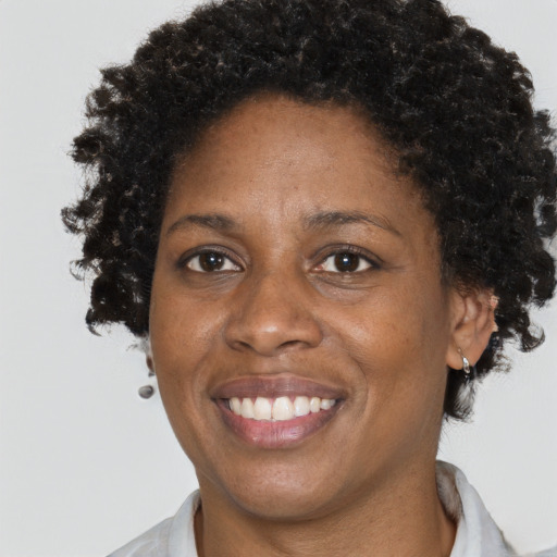 Joyful black adult female with short  brown hair and brown eyes