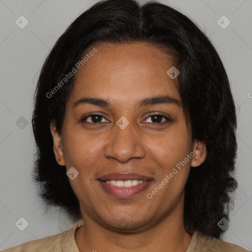 Joyful black young-adult female with long  brown hair and brown eyes