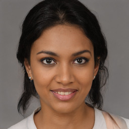 Joyful black young-adult female with medium  brown hair and brown eyes