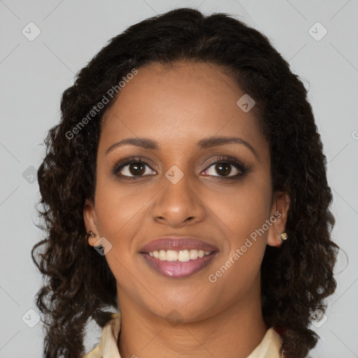 Joyful black young-adult female with long  brown hair and brown eyes