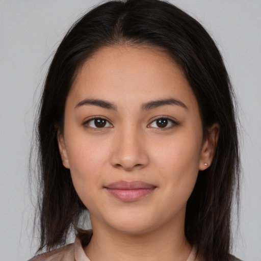 Joyful white young-adult female with long  brown hair and brown eyes