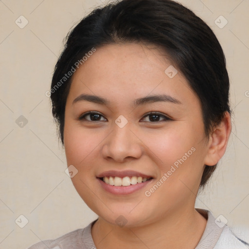 Joyful latino young-adult female with short  brown hair and brown eyes