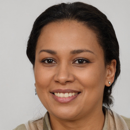 Joyful latino young-adult female with medium  brown hair and brown eyes