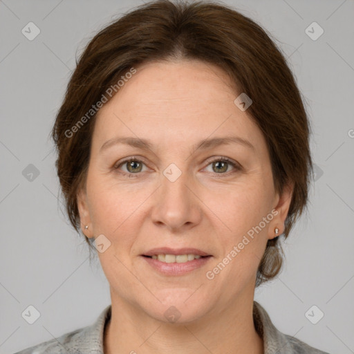 Joyful white adult female with medium  brown hair and grey eyes