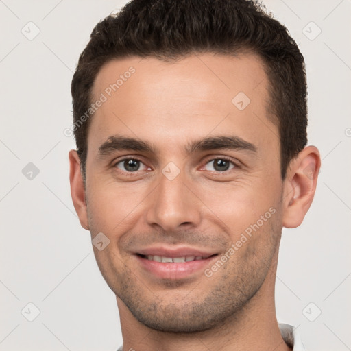 Joyful white young-adult male with short  brown hair and brown eyes