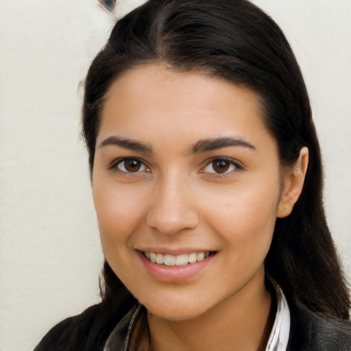 Joyful latino young-adult female with long  brown hair and brown eyes