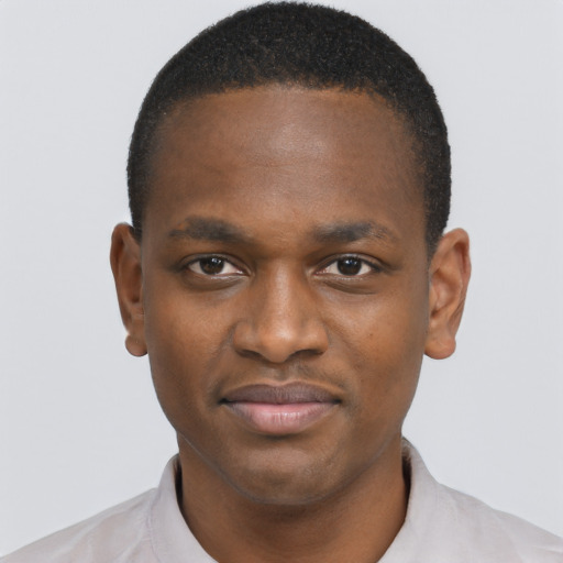 Joyful black young-adult male with short  brown hair and brown eyes