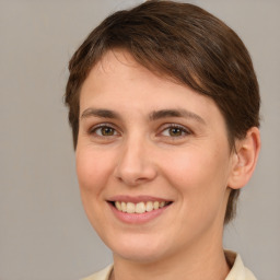 Joyful white young-adult female with medium  brown hair and brown eyes