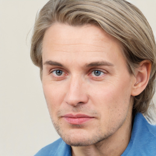 Joyful white adult male with short  brown hair and grey eyes