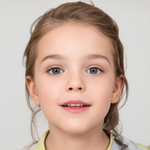 Joyful white child female with medium  brown hair and grey eyes