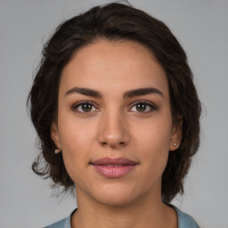 Joyful white young-adult female with medium  brown hair and brown eyes