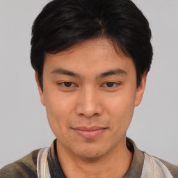 Joyful asian young-adult male with short  black hair and brown eyes