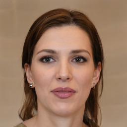 Joyful white young-adult female with medium  brown hair and brown eyes