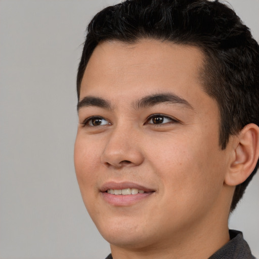 Joyful latino young-adult male with short  brown hair and brown eyes