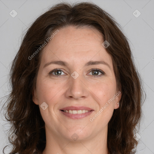 Joyful white adult female with medium  brown hair and green eyes