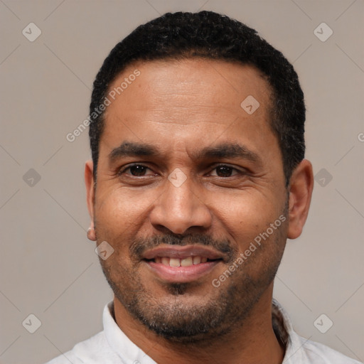 Joyful latino adult male with short  black hair and brown eyes