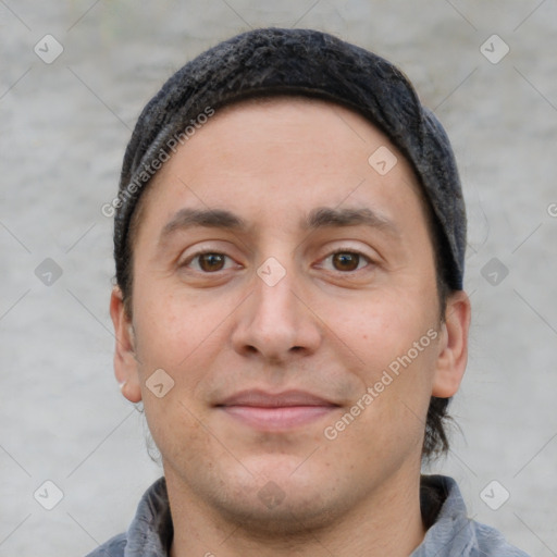 Joyful white adult male with short  brown hair and brown eyes