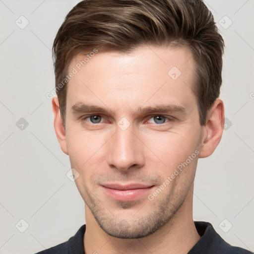 Joyful white young-adult male with short  brown hair and grey eyes