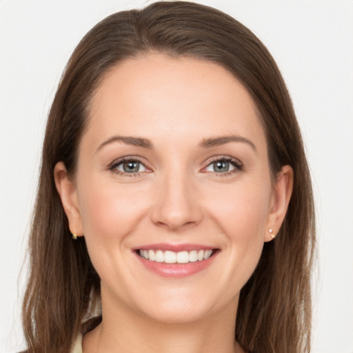 Joyful white young-adult female with long  brown hair and grey eyes