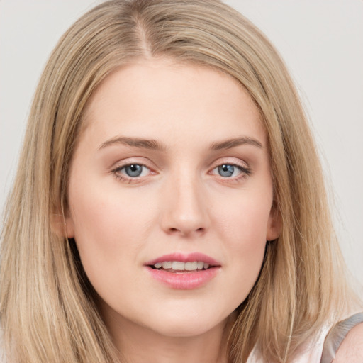 Joyful white young-adult female with long  brown hair and blue eyes