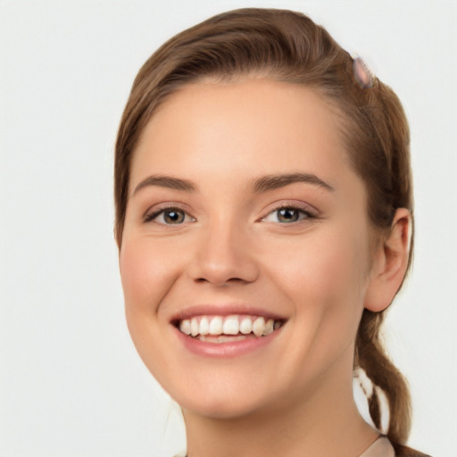 Joyful white young-adult female with short  brown hair and grey eyes