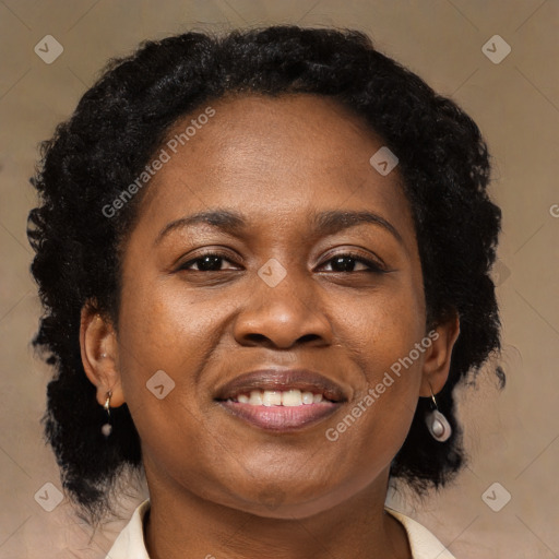 Joyful black adult female with medium  brown hair and brown eyes