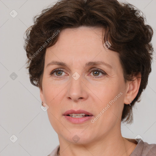 Joyful white adult female with medium  brown hair and blue eyes