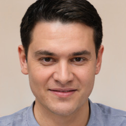 Joyful white young-adult male with short  brown hair and brown eyes