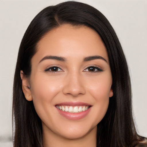 Joyful white young-adult female with long  black hair and brown eyes