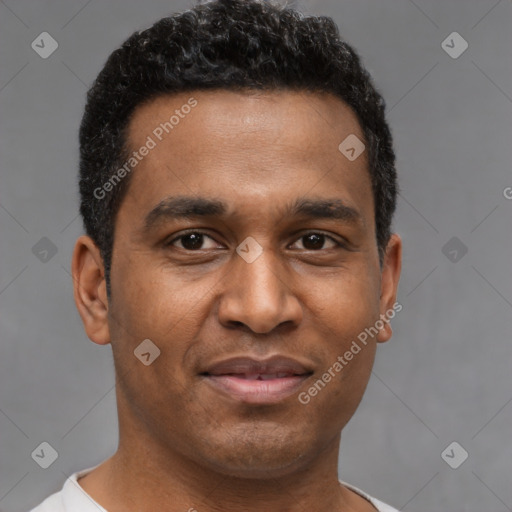 Joyful latino young-adult male with short  brown hair and brown eyes