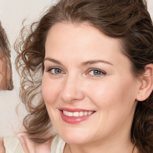 Joyful white young-adult female with medium  brown hair and blue eyes