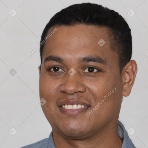 Joyful latino young-adult male with short  black hair and brown eyes