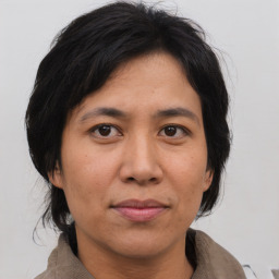 Joyful asian adult female with medium  brown hair and brown eyes