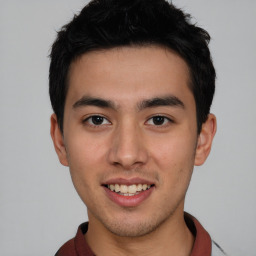 Joyful asian young-adult male with short  brown hair and brown eyes