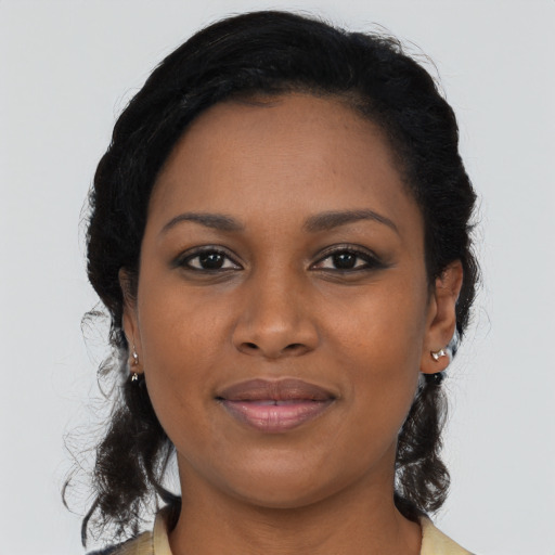 Joyful black young-adult female with medium  brown hair and brown eyes