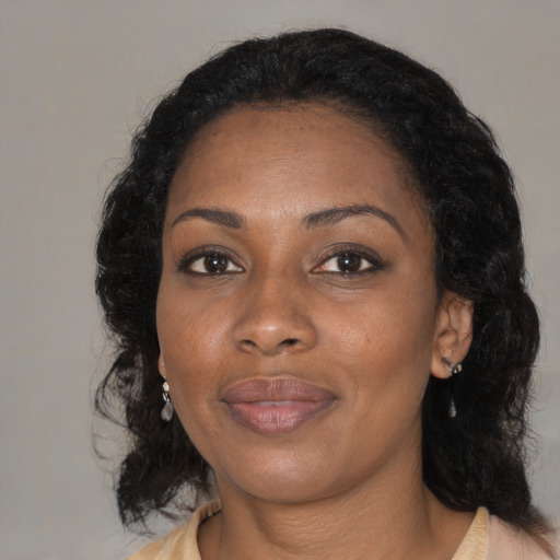 Joyful black young-adult female with medium  brown hair and brown eyes