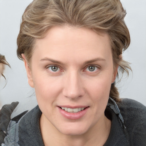 Joyful white young-adult female with medium  brown hair and blue eyes