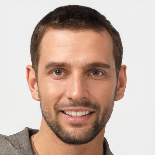 Joyful white young-adult male with short  brown hair and brown eyes