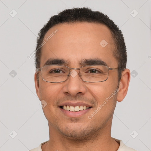 Joyful white young-adult male with short  black hair and brown eyes