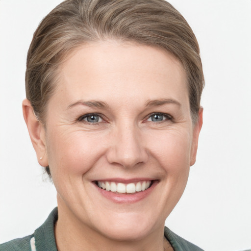 Joyful white young-adult female with short  brown hair and grey eyes