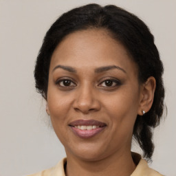 Joyful black adult female with medium  brown hair and brown eyes