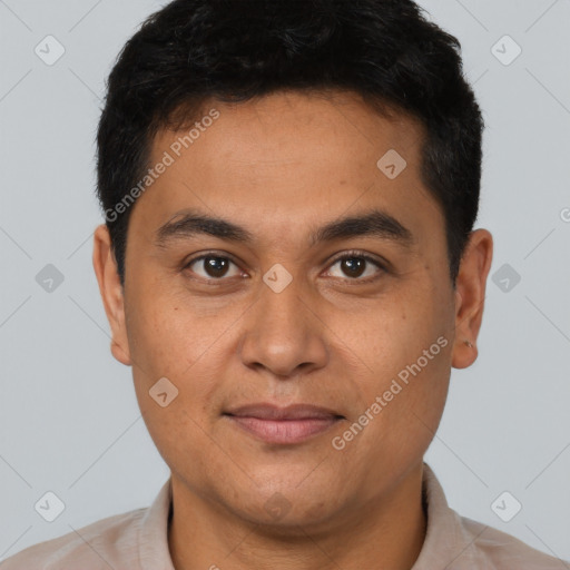 Joyful latino young-adult male with short  brown hair and brown eyes