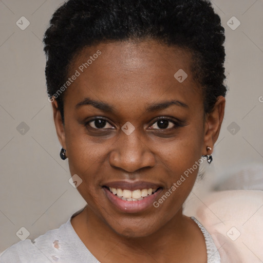 Joyful black young-adult female with short  black hair and brown eyes