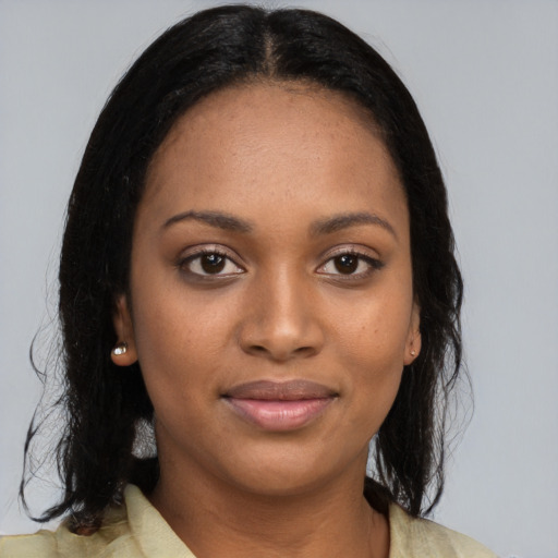 Joyful black young-adult female with medium  black hair and brown eyes