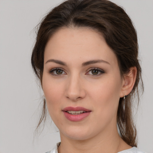 Joyful white young-adult female with medium  brown hair and brown eyes