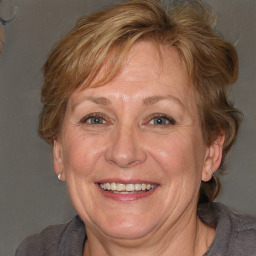 Joyful white middle-aged female with medium  brown hair and brown eyes