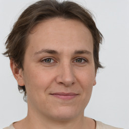 Joyful white adult female with short  brown hair and grey eyes